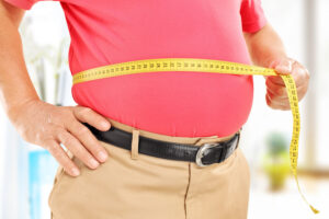 older man measuring his waist